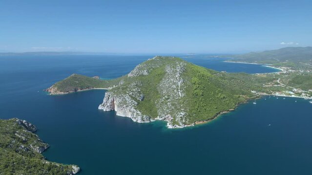 Cinematic sidweways moving 4K drone clip over the tropical blue waters of Toroni in Chalkidiki