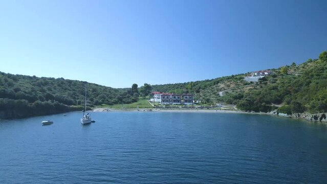 Cinematic backwards moving 4K drone clip over the tropical blue waters of Toroni in Chalkidiki
