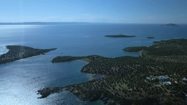 Cinematic sidweways moving 4K drone clip over the tropical blue waters of Toroni in Chalkidiki