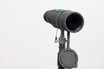 Monocular on a tripod isolated on a white field.