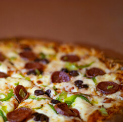 Close up shots of a delicious pepperoni pizza with Mozzarella cheese, salami, pepper, and fresh olives  Italian pizza