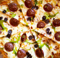 Close up shots of a delicious pepperoni pizza with Mozzarella cheese, salami, pepper, and fresh olives  Italian pizza