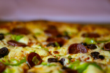 Close up shots of a delicious pepperoni pizza with Mozzarella cheese, salami, pepper, and fresh olives  Italian pizza