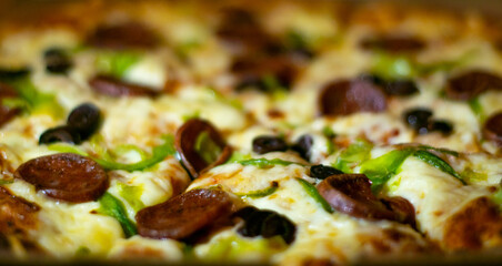 Close up shots of a delicious pepperoni pizza with Mozzarella cheese, salami, pepper, and fresh olives  Italian pizza