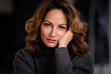 Fototapeta premium Close-up portrait of an attractive mid aged woman looking thoughtfully