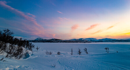 Pink sky and blue snow. Winter sunset in Finland