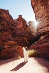 a woman standing in the middle of a desert
Amongst expansive red sands and spectacular sandstone...