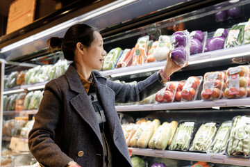 Professional Woman Picking Fresh Vegetables at Store