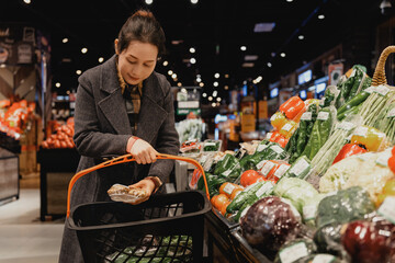 Young Woman Choosing Fresh Vegetables in Grocery Store