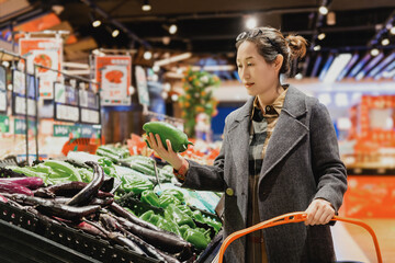 Woman Choosing Fresh Vegetables at Grocery Store