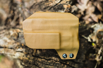 objective holster shooting on dry leaves in the forest