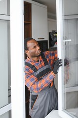 Fototapeta na wymiar African service man installing window