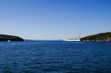 Large family cruiseship cruise ship liner Dawn anchoring in Bar Harbour Bay on sunny blue sky day during scenic New England Indian Summer adventure nature cruising