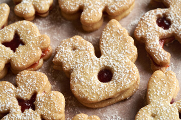 Linzer cookies in the shape of Easter chicken and bunnies filled with marmalade and dusted with sugar