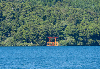 A“red gate of peace” (heiwa no torii) in Hakone-jinja shrine standing proud and tall in Ashinoko Lake, Kanagawa prefecture, Japan 