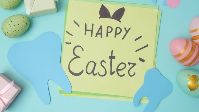 Dental layout with teeth figurines and postcard with Happy Easter text.
