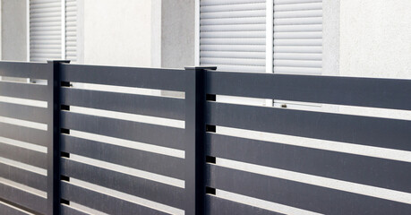 : Modern stone fence with aluminum or metal shutter  - obrazy, fototapety, plakaty