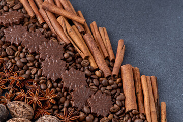 Food background. Coffee beans, cinnamon sticks, anise stars and chocolate candies top view.