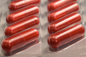 Detail of blister of red pills for medication horizontally with macro shot