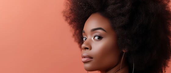 Fototapeta premium Stunning portrait of a woman with a voluminous afro, embodying confidence and natural beauty