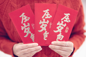 Woman holding red envelope in hand