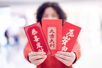 Woman holding red envelope in hand