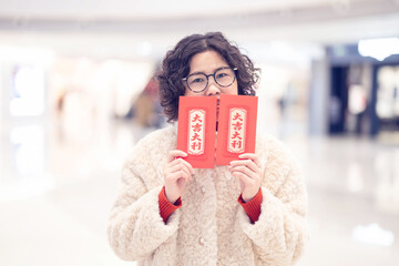 Woman happily holding the Spring Festival red envelope she received