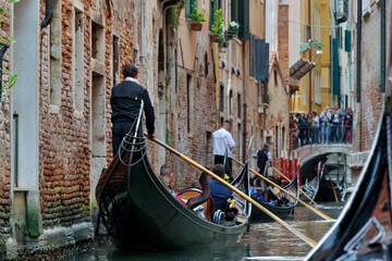 Fototapeta na wymiar A Gondola Ride in Venice. Gondoliers On the Grand Canal. Venice Travel
