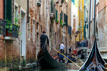 A Gondola Ride in Venice. Gondoliers On the Grand Canal. Venice Travel - obrazy, fototapety, plakaty