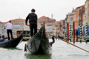 Fototapeta na wymiar A Gondola Ride in Venice. Gondoliers On the Grand Canal. Venice Travel