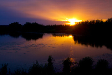 Sunbeams out of the cloud cover just before the sunset and dusk