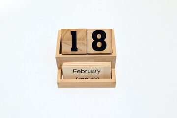 18th of February wooden perpetual calendar. Shot close up isolated on a white background