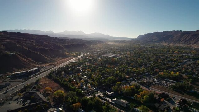 Drone shot panning to the left of Moab, Utah at sunrise