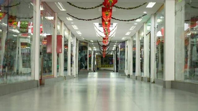 Still Shot Of The Hallways Of A Shopping Center Without People, With Lights Off And The Lights Suddenly Turn On