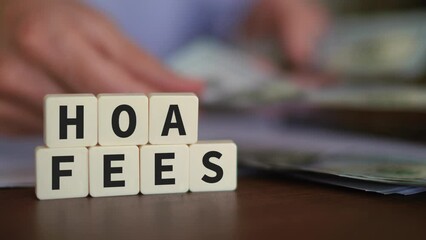 Concept of Homeowners Association Fees. HOA Fees word with Selective focus and money on the background.