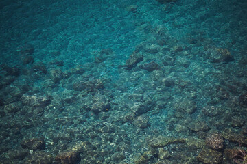 Fototapeta na wymiar seaside. texture of the sea coast. The sea view, the rocks on the beach with turquoise sea water. Liguria , Italy.
