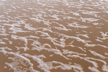 Sea foam on the beach