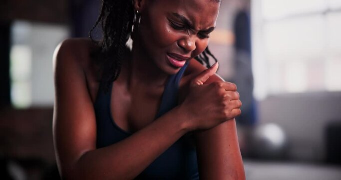 Shoulder pain, hands and black woman at a gym with fitness crisis, mistake or workout, accident or disaster. Joint, arm and African female athlete with sports injury, arthritis or osteoporosis stress