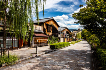 Traditional wooden building burnt down on a quiet Kyoto street on a sunny summer's day. Authentic...