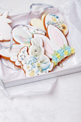 Pastel gift box with Easter decorated glazed cookies. Spring cozy aesthetics background