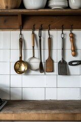 Various utensils hanging on a kitchen wall. Perfect for showcasing a well-organized kitchen setup