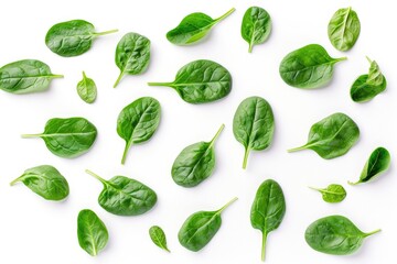 Spinach leaves arranged in a group on a clean white surface. Suitable for food and health-related designs