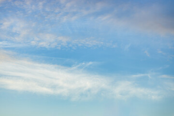 A beautiful sky tinted by the sun leaving vibrant shades of gold, pink, blue and multicolored. Clouds in the twilight evening and morning sky. Cloudy sky background in the evening and during the day.