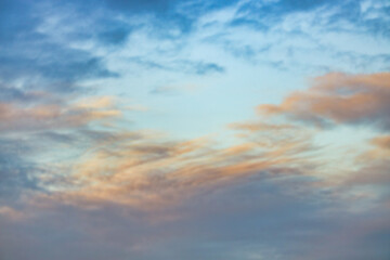 A beautiful sky tinted by the sun leaving vibrant shades of gold, pink, blue and multicolored. Clouds in the twilight evening and morning sky. Cloudy sky background in the evening and during the day.