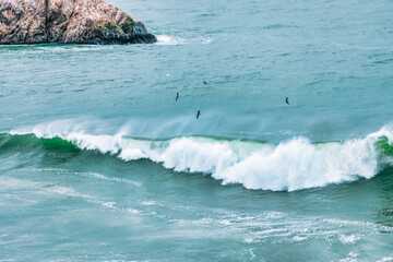 Wave splashing close-up. Crystal clear sea water, in the ocean in San Francisco Bay, blue water, pastel colors.