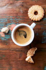 Cup of coffee on wooden background. Close up. Top view. 