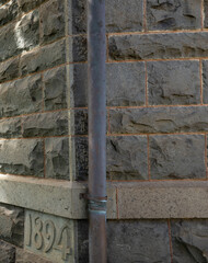 Old Granite Wall Dated 1894 with a Copper Rain Drain.