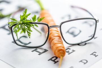 Dioptric glasses and how we have carrots. Fun photo for healthy eyesight. Glasses and carrot,...