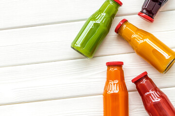 bottles with fresh carrot, tomato, apple, cucumber, lemon, pomegranate juices on white background...