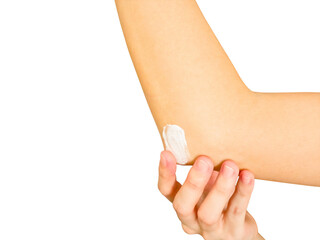 Woman applying moisturizing cream on elbow